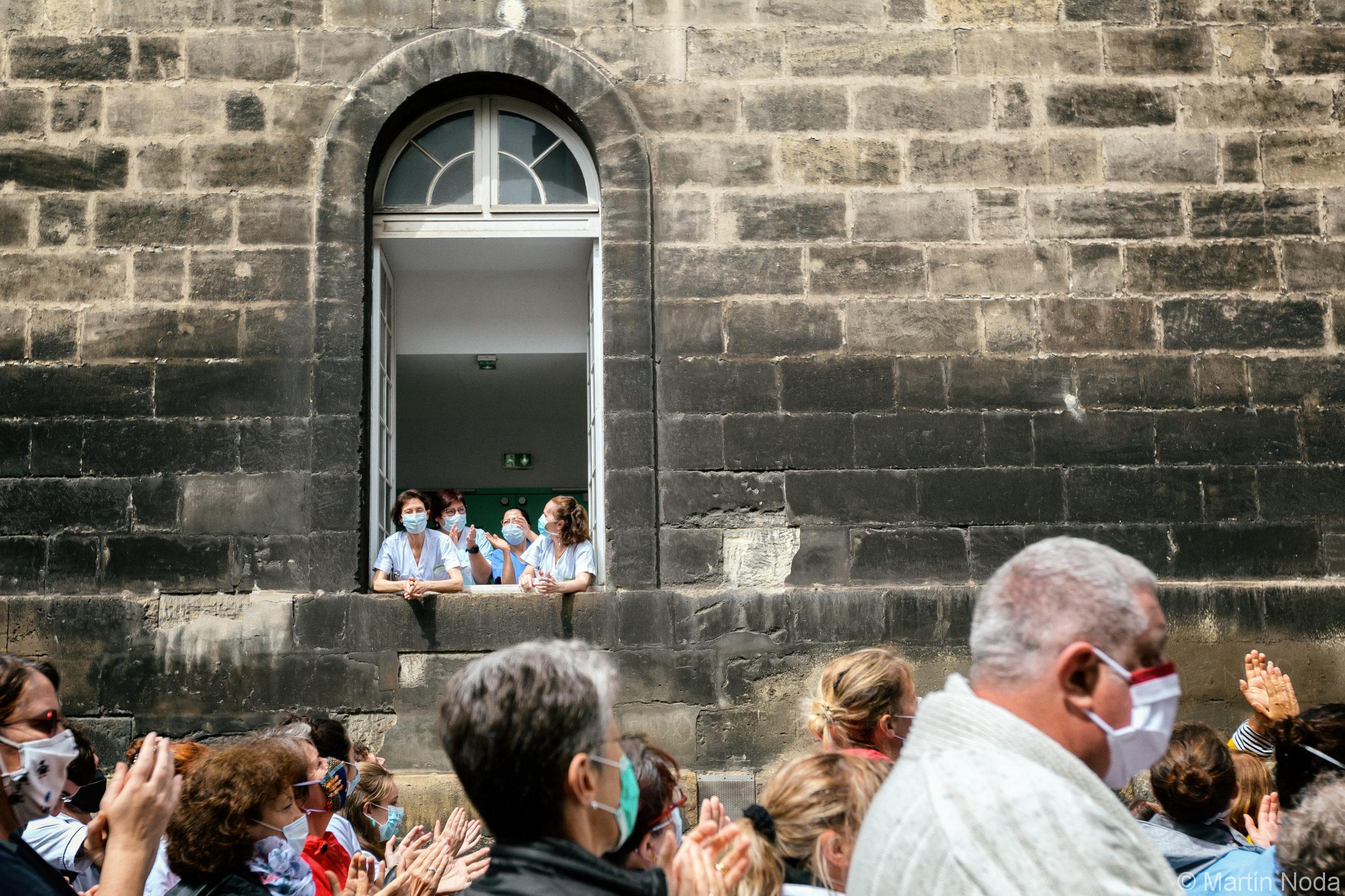 Des soignantes sortent aux fenêtres de l'hôpital Sainte Ambroise pour saluer la manifestation, manifestation en soutien du personnel soignant, Bordeaux, 16 juin 2020.
